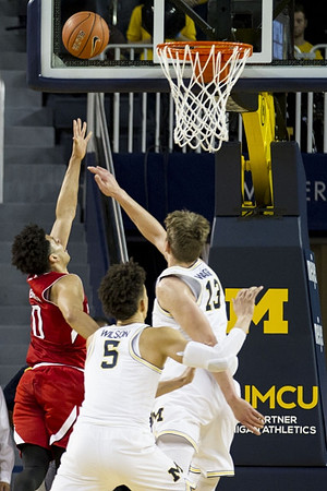 D.J. Wilson (5) and Moritz Wagner (13)