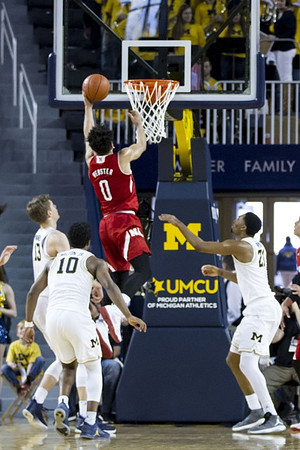 Moritz Wagner (13), Derrick Walton Jr. (10), and Zak Irvin (21)