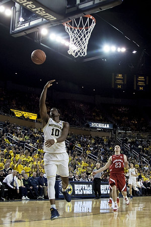 Derrick Walton Jr. (10), John Beilein, and D.J. Wilson (5)