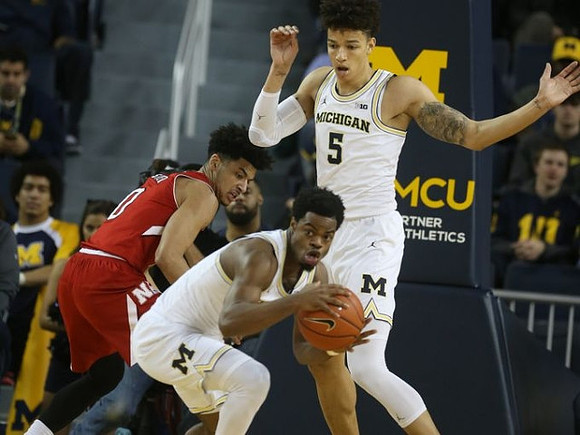 D.J. Wilson (5) and Derrick Walton Jr. (10)
