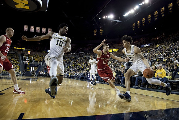 Derrick Walton Jr. (10), Muhammad-Ali Abdur-Rahkman (12), and D.J. Wilson (5)