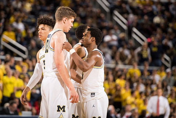 D.J. Wilson (5), Moritz Wagner (13), Zak Irvin (21), and Derrick Walton Jr. (10)