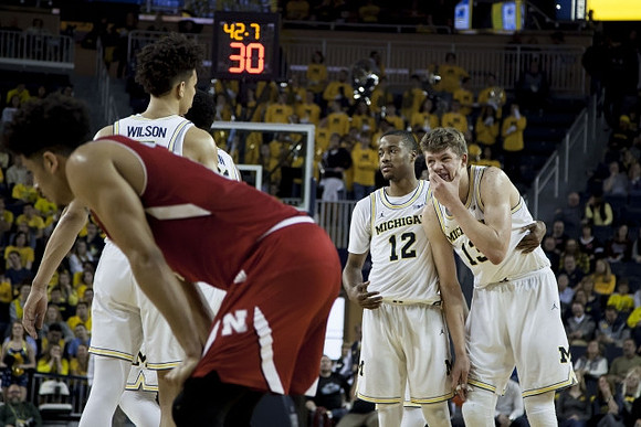 D.J. Wilson (5), Muhammad-Ali Abdur-Rahkman (12), and Moritz Wagner (13)