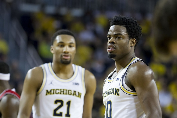 Zak Irvin (21) and Derrick Walton Jr. (10)