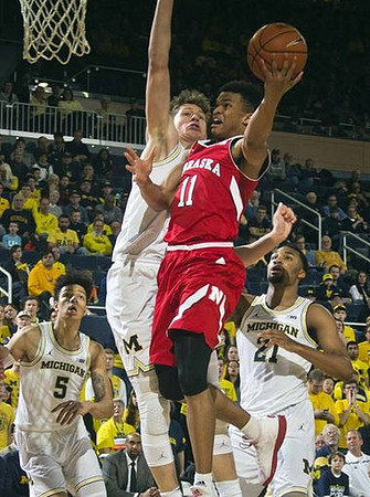 D.J. Wilson (5), Moritz Wagner (13), and Zak Irvin (21)