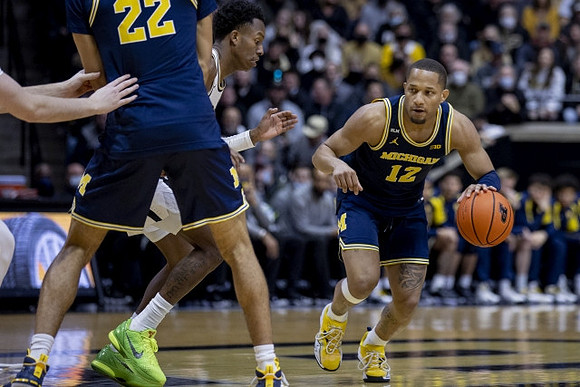 Caleb Houstan (22) and DeVante' Jones (12)