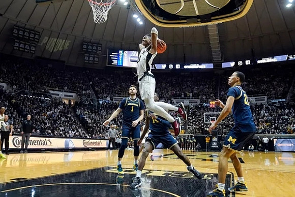 Hunter Dickinson (1), Moussa Diabate (14), and Caleb Houstan (22)