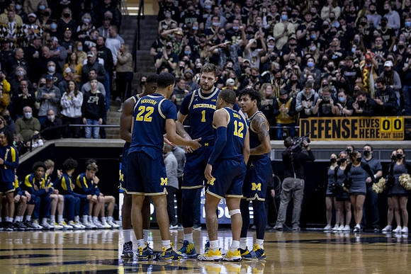 Caleb Houstan (22), Moussa Diabate (14), Hunter Dickinson (1), DeVante' Jones (12), and Eli Brooks (55)