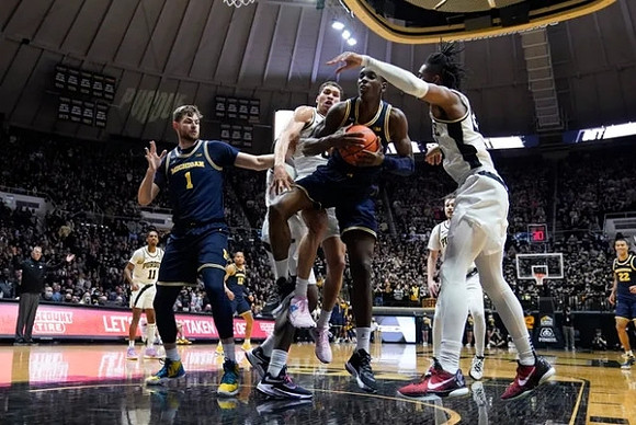 Hunter Dickinson (1), Moussa Diabate (14), DeVante' Jones (12), and Caleb Houstan (22)