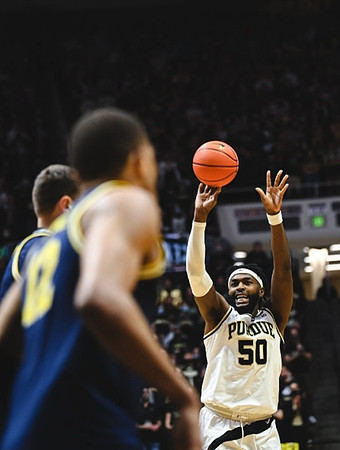Hunter Dickinson (1) and DeVante' Jones (12)