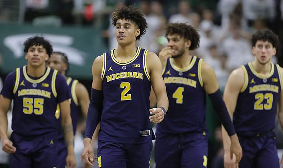 Eli Brooks (55), Zavier Simpson (3), Jordan Poole (2), Isaiah Livers (4), and Brandon Johns Jr. (23)