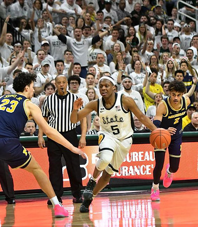 Brandon Johns Jr. (23) and Jordan Poole (2)