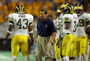 Lloyd Carr, Carl Diggs (43), Marlin Jackson (3), and Pierre Woods (99)