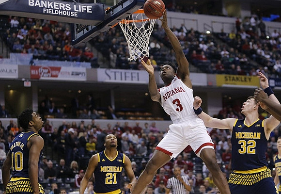 Derrick Walton Jr. (10), Zak Irvin (21), and Ricky Doyle (32)