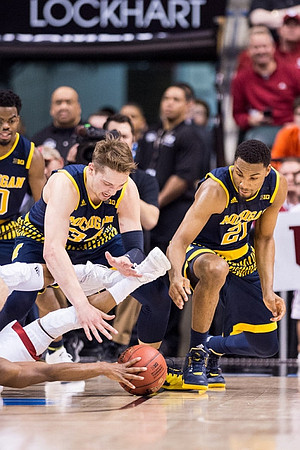 Derrick Walton Jr. (10), Mark Donnal (34), and Zak Irvin (21)