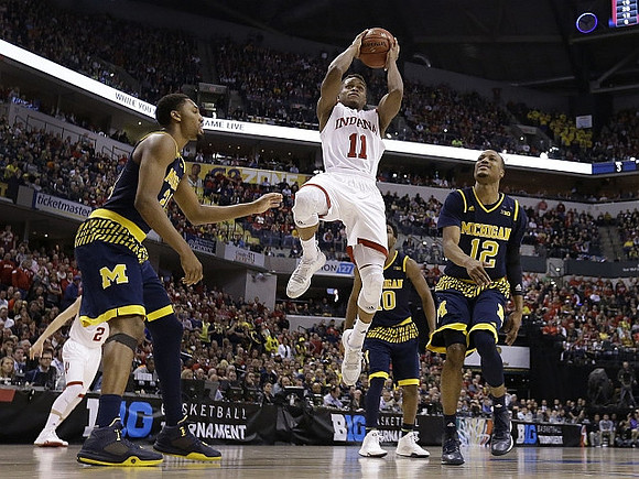 Zak Irvin (21), Derrick Walton Jr. (10), and Muhammad-Ali Abdur-Rahkman (12)