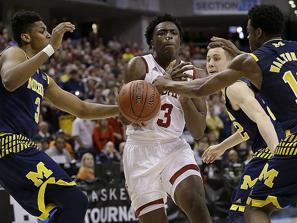 Kameron Chatman (3), Duncan Robinson (22), and Derrick Walton Jr. (10)