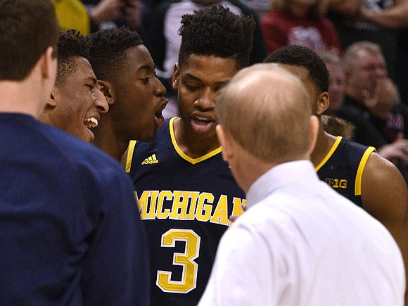 Aubrey Dawkins (24), Caris LeVert (23), Kameron Chatman (3), and John Beilein