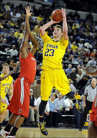 Zack Novak (0) and Evan Smotrycz (23)