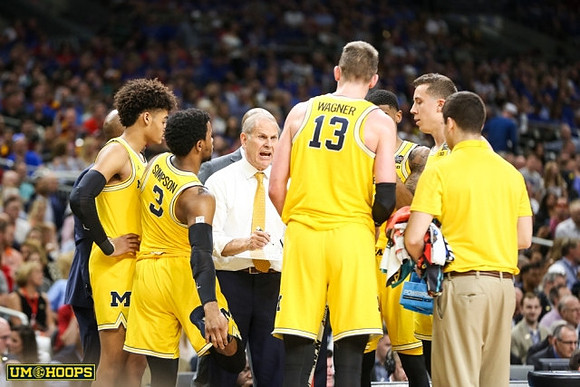 Jordan Poole (2), Zavier Simpson (3), John Beilein, Moritz Wagner (13), Charles Matthews (1), and Duncan Robinson (22)