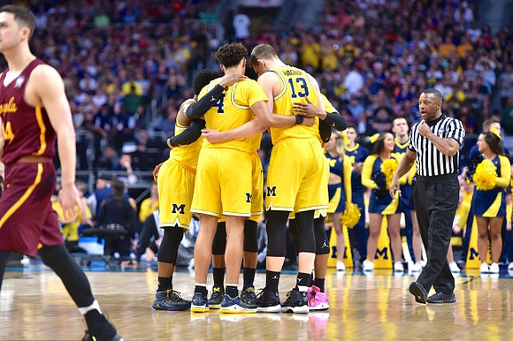 Zavier Simpson (3), Isaiah Livers (4), and Moritz Wagner (13)