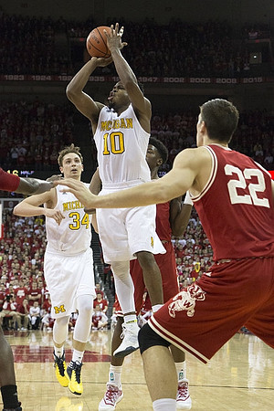 Mark Donnal (34) and Derrick Walton Jr. (10)