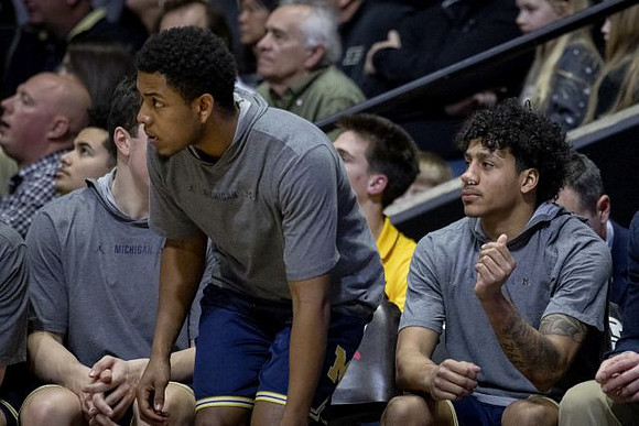 C.J. Baird (24), Rico Ozuna-Harrison (14), and Eli Brooks (55)