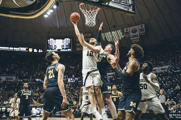 Zavier Simpson (3), Franz Wagner (21), Jon Teske (15), David DeJulius (0), and Isaiah Livers (2)