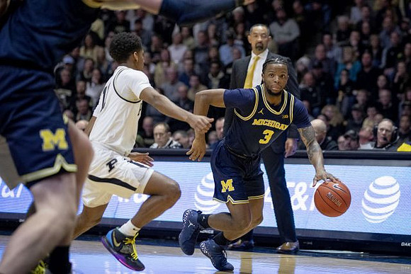Zavier Simpson (3) and Juwan Howard