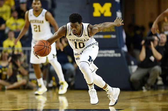 Zak Irvin (21) and Derrick Walton Jr. (10)