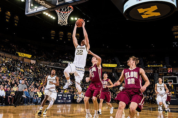 Zak Irvin (21), Duncan Robinson (22), and D.J. Wilson (5)