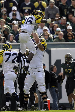 Mark Huyge (72), Denard Robinson (16), and Taylor Lewan (77)