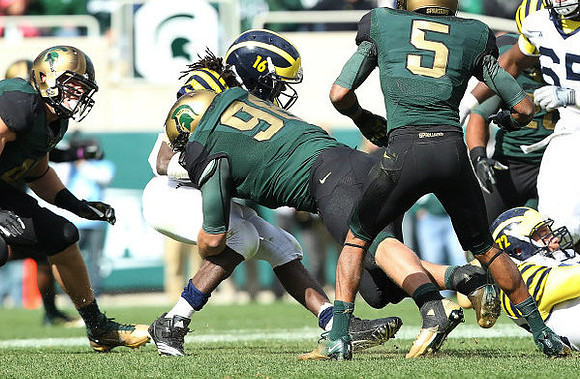 Denard Robinson (16) and Mark Huyge (72)