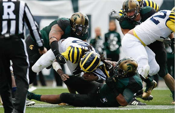 Denard Robinson (16) and Mark Huyge (72)