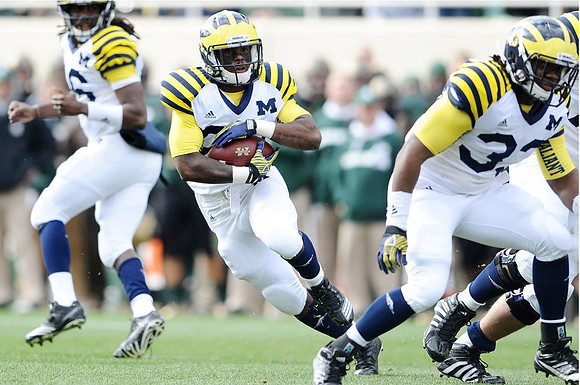 Denard Robinson (16), Fitzgerald Toussaint (28), and Stephen Hopkins (33)