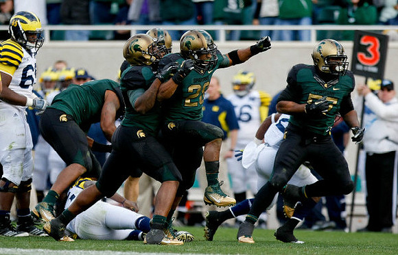 Patrick Omameh (65) and Denard Robinson (16)