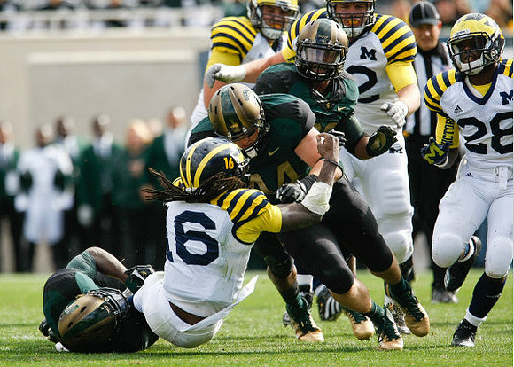 Denard Robinson (16), Mark Huyge (72), and Fitzgerald Toussaint (28)