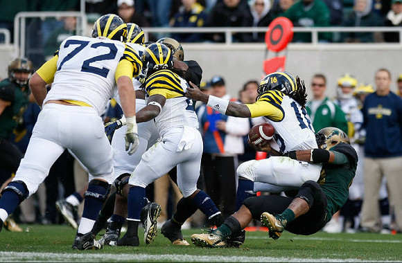 Mark Huyge (72), Vincent Smith (2), and Denard Robinson (16)