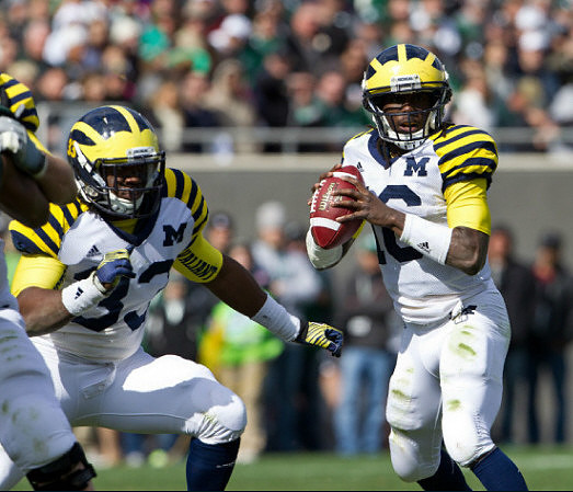 Stephen Hopkins (33) and Denard Robinson (16)