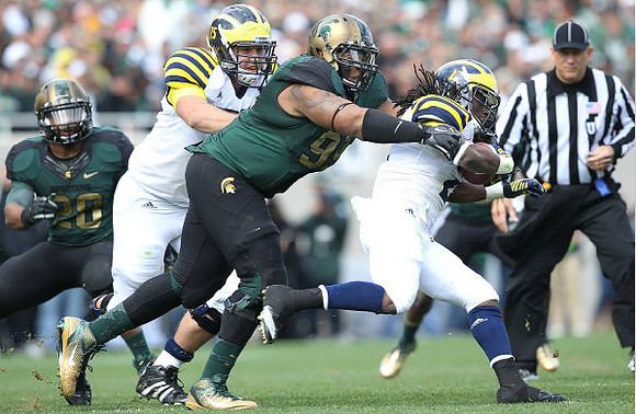 Michael Schofield (75) and Denard Robinson (16)