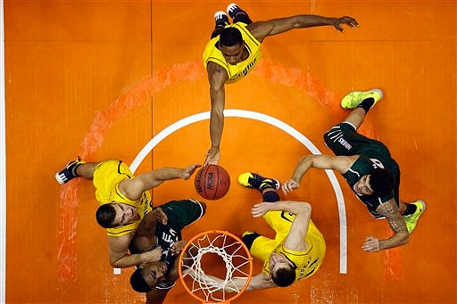 Mitch McGary (4), Glenn Robinson III (1), and Nik Stauskas (11)