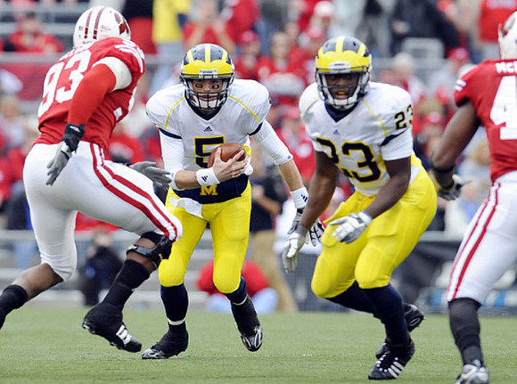 Tate Forcier (5) and Carlos Brown (23)
