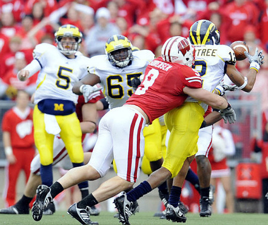 Tate Forcier (5), Patrick Omameh (65), and Roy Roundtree (12)