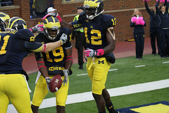 Mike Kwiatkowski (81), Devin Funchess (19), and Devin Gardner (12)
