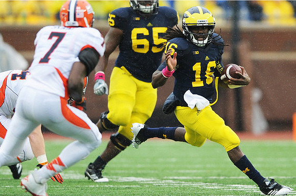 Patrick Omameh (65) and Denard Robinson (16)