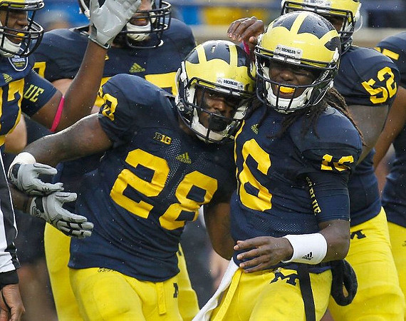 Fitzgerald Toussaint (28), Denard Robinson (16), and Ricky Barnum (52)