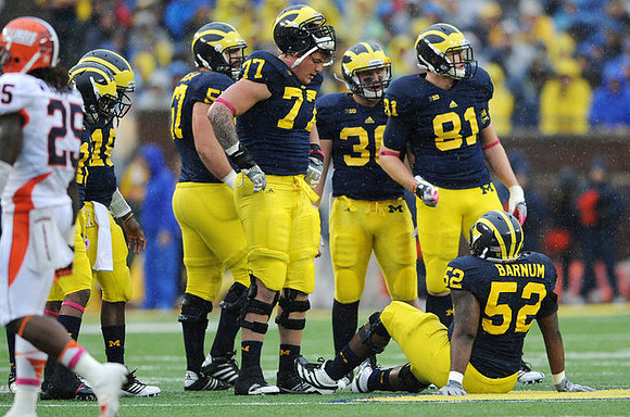 Roy Roundtree (21), Denard Robinson (16), Elliott Mealer (57), Taylor Lewan (77), Joe Kerridge (36), Mike Kwiatkowski (81), and Ricky Barnum (52)