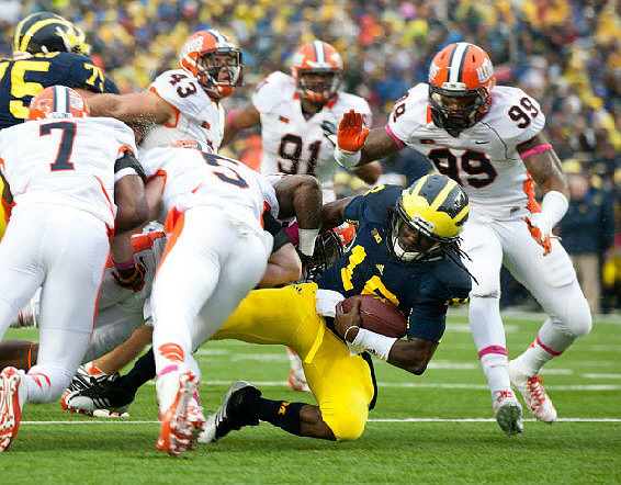 Michael Schofield (75) and Denard Robinson (16)