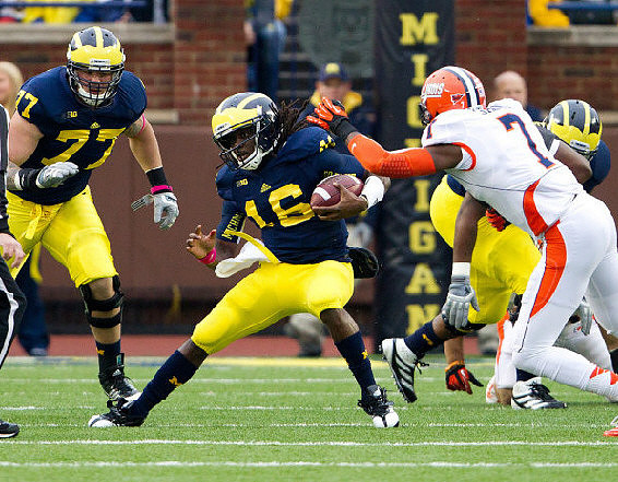 Taylor Lewan (77) and Denard Robinson (16)