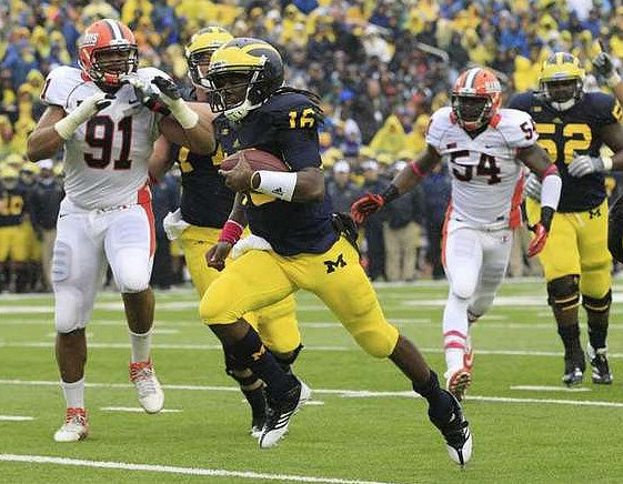 Denard Robinson (16), Taylor Lewan (77), and Ricky Barnum (52)